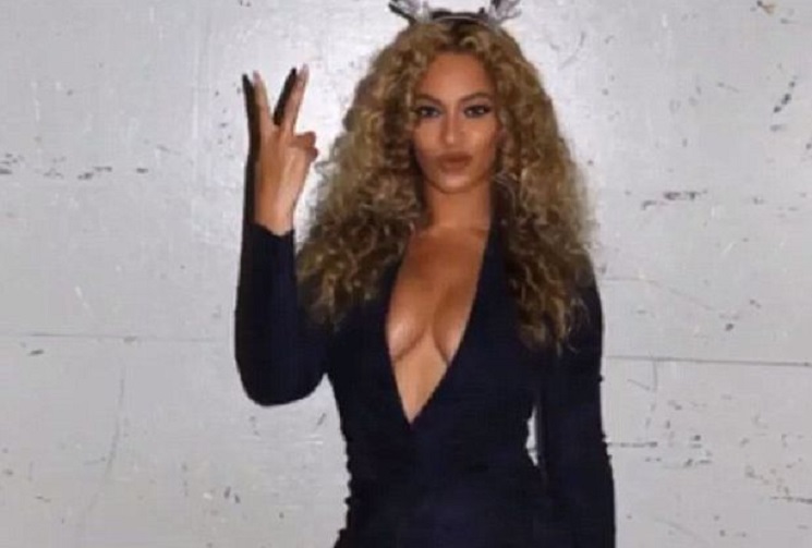 Nobody’s looking at the tree! Beyonce shows off her festive baubles in plunging dress