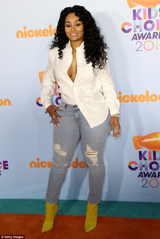 Blac Chyna risks a wardrobe malfunction in plunging white shirt as she takes son King Cairo to Kids’ Choice Awards