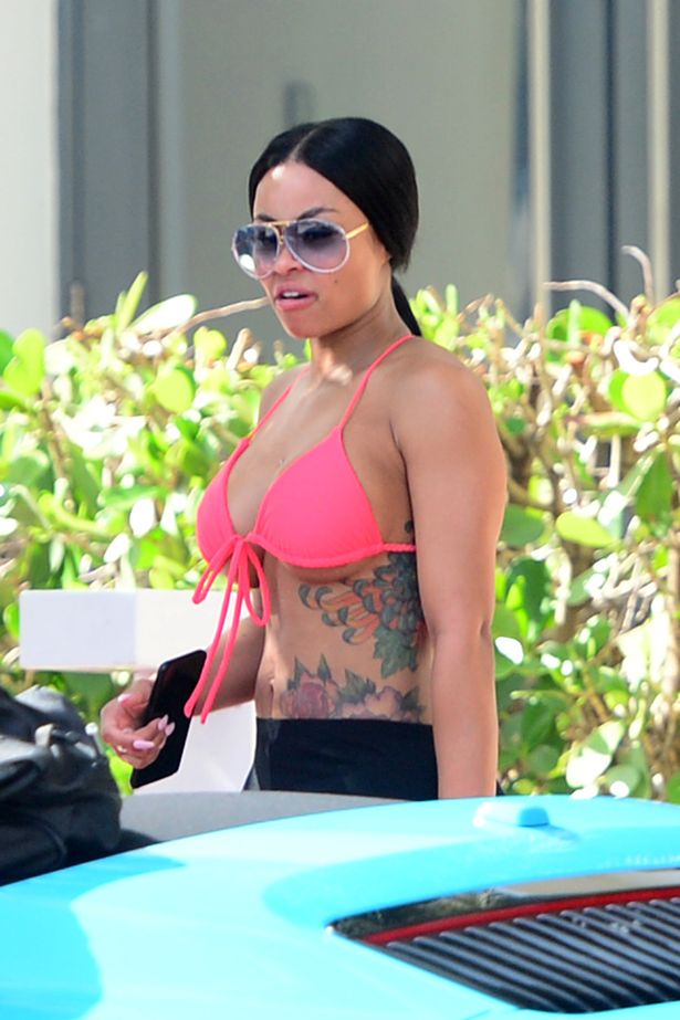 Blac Chyna displays tiny post-pregnancy tummy in bright bikini after bumping into ex Tyga on girl getaway to Miami