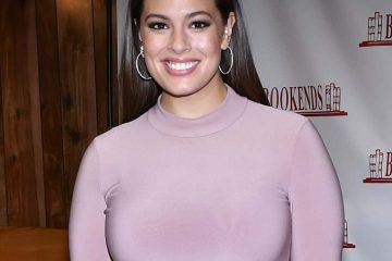 Lovely in lavender: Ashley Graham shoehorns her fuller figure into skintight dress as she promotes new memoir