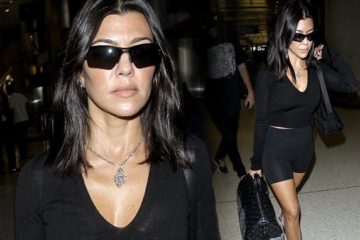 Kourtney Kardashian saunters through the airport wearing skintight bike shorts and sporty sunglasses